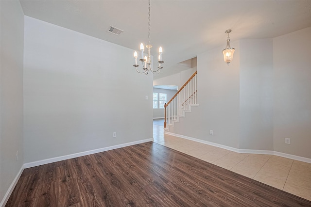24523 Carlton Springs Ln, Katy, TX 77494 - unfurnished room featuring wood finished floors, a chandelier, stairs, and baseboards