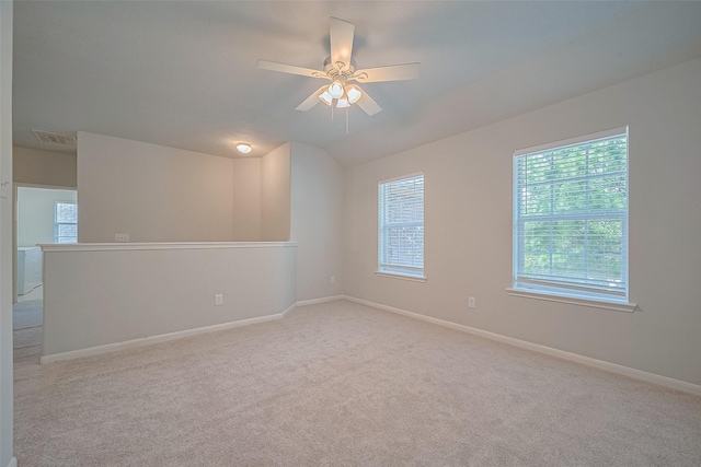 24523 Carlton Springs Ln, Katy, TX 77494 - spare room featuring light carpet, ceiling fan, baseboards, and lofted ceiling