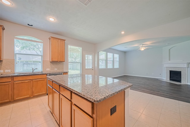 24523 Carlton Springs Ln, Katy, TX 77494 - kitchen with ceiling fan, a kitchen island, a sink, light tile patterned flooring, and recessed lighting