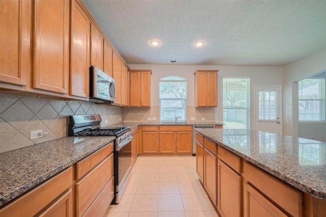 24523 Carlton Springs Ln, Katy, TX 77494 - kitchen featuring stainless steel appliances, a sink, healthy amount of natural light, light tile patterned flooring, and recessed lighting