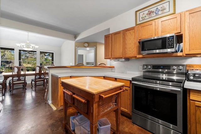 1726 Bowler Rd, Waller, TX 77484 - kitchen with stainless steel appliances, a chandelier, a peninsula, concrete flooring, and brown cabinetry