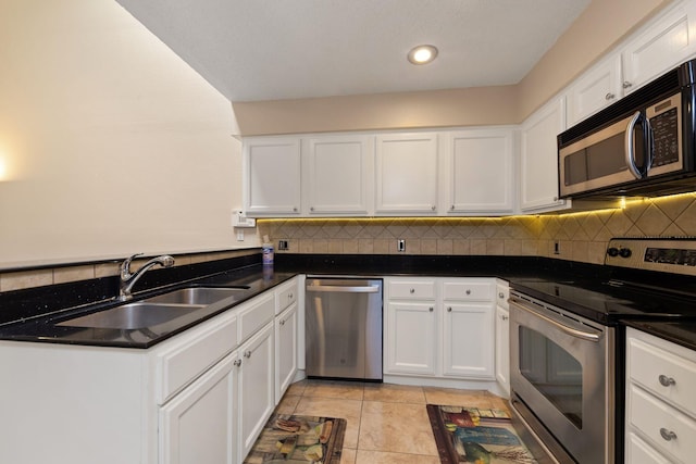 2611 Grants Lake Blvd Unit 222, Sugar Land, TX 77479 - kitchen with appliances with stainless steel finishes, white cabinetry, decorative backsplash, and recessed lighting