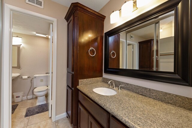 2611 Grants Lake Blvd Unit 222, Sugar Land, TX 77479 - half bath with toilet, vanity, tile patterned floors, and baseboards