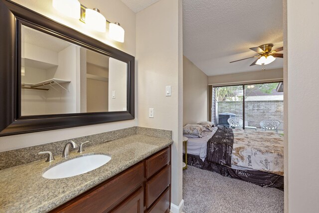 2611 Grants Lake Blvd Unit 222, Sugar Land, TX 77479 - bathroom featuring vanity, a textured ceiling, and ceiling fan