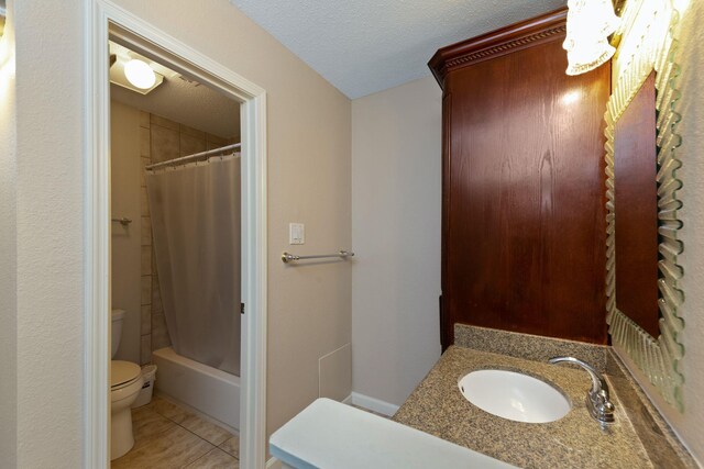 2611 Grants Lake Blvd Unit 222, Sugar Land, TX 77479 - bathroom with toilet, tile patterned floors, vanity, shower / bathtub combination with curtain, and a textured ceiling
