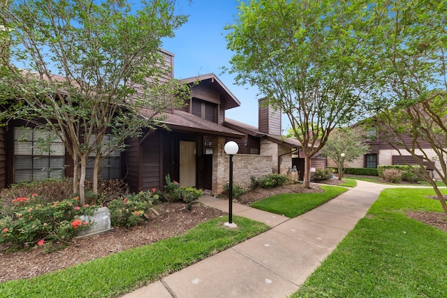 2611 Grants Lake Blvd Unit 222, Sugar Land, TX 77479 - view of front of property featuring a chimney and a front yard