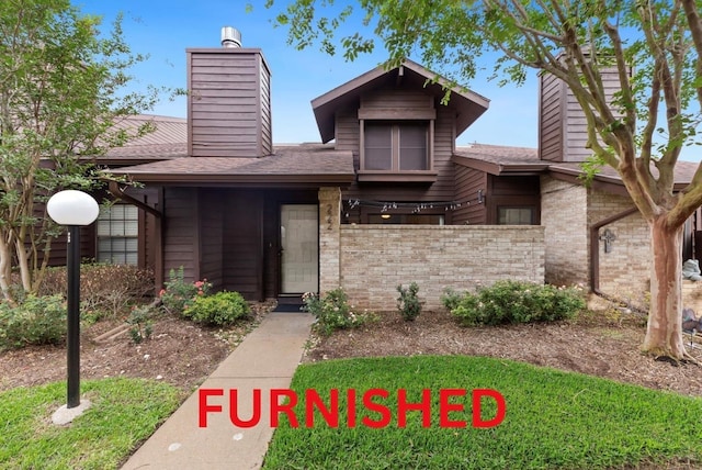 2611 Grants Lake Blvd Unit 222, Sugar Land, TX 77479 - view of front of house featuring a chimney, roof with shingles, and brick siding