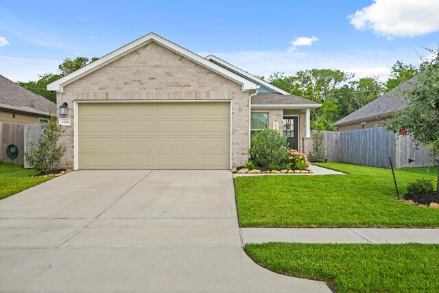 1174 Filly Creek Dr, Alvin, TX 77511 - view of front facade featuring driveway, brick siding, and an attached garage