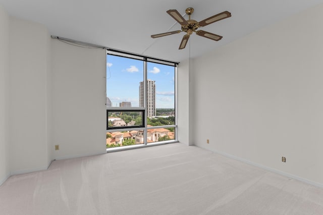 5100 San Felipe St Unit 98, Houston, TX 77056 - carpeted spare room featuring a wall of windows, ceiling fan, and a city view
