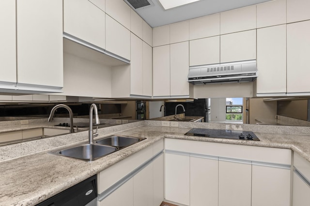 5100 San Felipe St Unit 98, Houston, TX 77056 - kitchen with black electric cooktop, exhaust hood, light countertops, and dishwashing machine