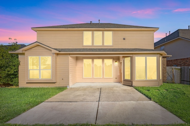 20522 Saddleback Chase Ln, Cypress, TX 77433 - back of property at dusk featuring a patio area and roof with shingles