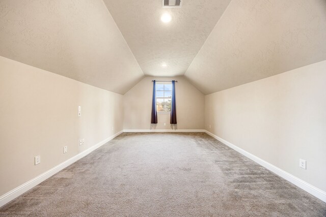 20522 Saddleback Chase Ln, Cypress, TX 77433 - bonus room with a textured ceiling, baseboards, vaulted ceiling, and carpet