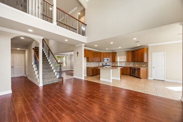20522 Saddleback Chase Ln, Cypress, TX 77433 - unfurnished living room featuring ornamental molding, baseboards, stairway, light wood-type flooring, and recessed lighting
