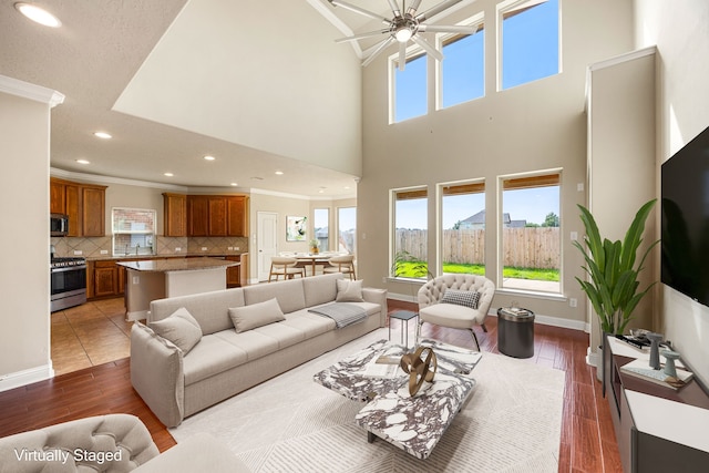 20522 Saddleback Chase Ln, Cypress, TX 77433 - living area with crown molding, wood finished floors, a ceiling fan, recessed lighting, and a high ceiling
