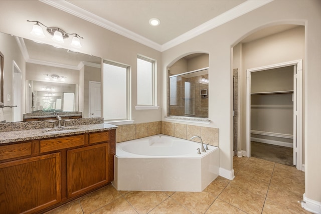 20522 Saddleback Chase Ln, Cypress, TX 77433 - bathroom with a stall shower, vanity, a bath, a spacious closet, and tile patterned flooring