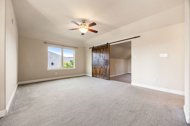 20522 Saddleback Chase Ln, Cypress, TX 77433 - unfurnished bedroom featuring carpet, baseboards, a barn door, vaulted ceiling, and ceiling fan