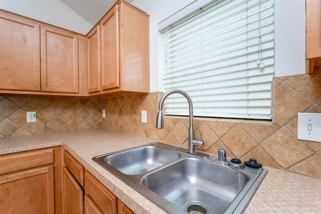 5811 Laramie River Ct, Katy, TX 77449 - kitchen featuring a sink, tasteful backsplash, and light countertops