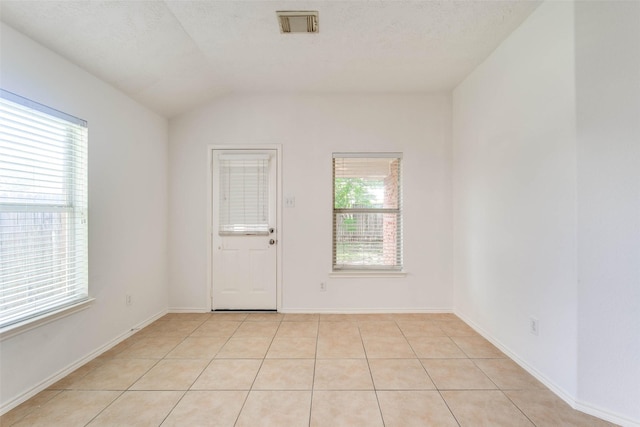 5811 Laramie River Ct, Katy, TX 77449 - unfurnished room featuring light tile patterned floors and lofted ceiling