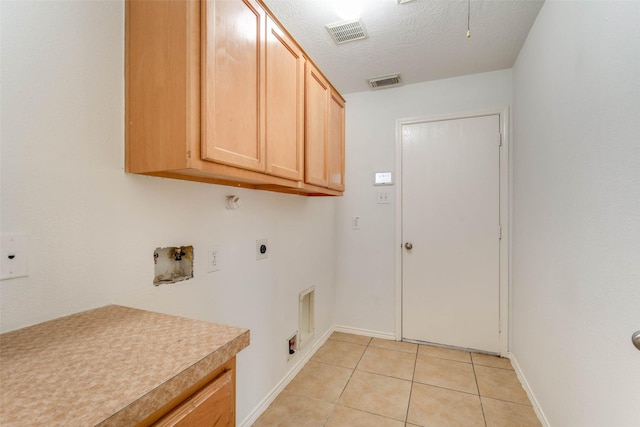 5811 Laramie River Ct, Katy, TX 77449 - washroom with cabinet space, hookup for an electric dryer, light tile patterned flooring, baseboards, and hookup for a washing machine