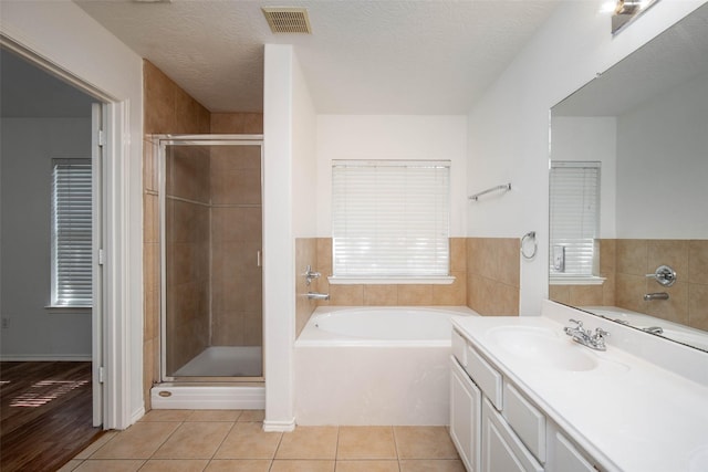5811 Laramie River Ct, Katy, TX 77449 - bathroom featuring a bath, vanity, a shower stall, and tile patterned flooring