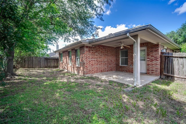 5811 Laramie River Ct, Katy, TX 77449 - view of side of property featuring brick siding, a ceiling fan, a patio area, and a fenced backyard