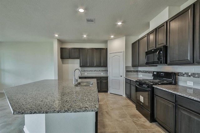 28430 Buffalo Fork Ln, Katy, TX 77494 - kitchen with black appliances, a sink, decorative backsplash, dark brown cabinets, and stone counters