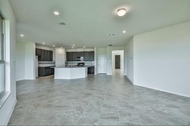 28430 Buffalo Fork Ln, Katy, TX 77494 - unfurnished living room with recessed lighting, baseboards, and a sink