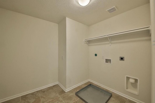 28430 Buffalo Fork Ln, Katy, TX 77494 - laundry room with electric dryer hookup, hookup for a washing machine, baseboards, a textured ceiling, and tile patterned flooring
