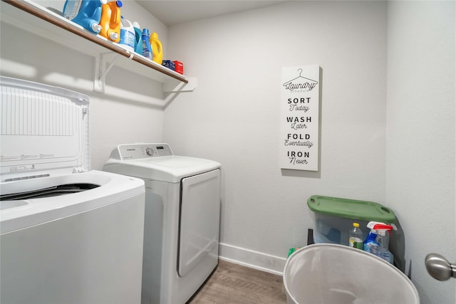 4426 Ibiza Ln, Houston, TX 77045 - washroom featuring washer and clothes dryer and wood finished floors