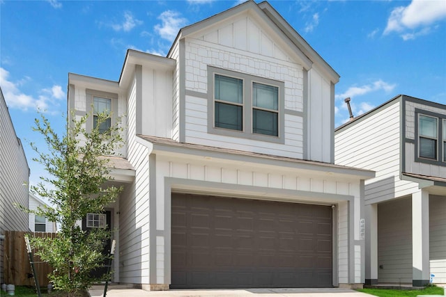 4426 Ibiza Ln, Houston, TX 77045 - view of front of house with board and batten siding, a garage, and driveway