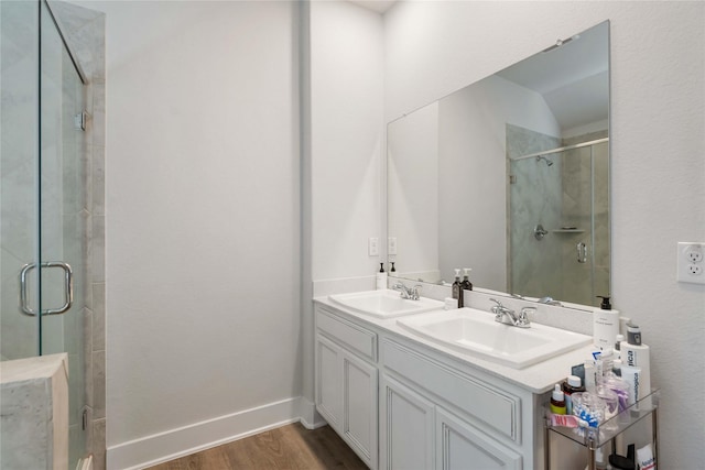 4426 Ibiza Ln, Houston, TX 77045 - full bathroom featuring wood finished floors, a stall shower, and double vanity