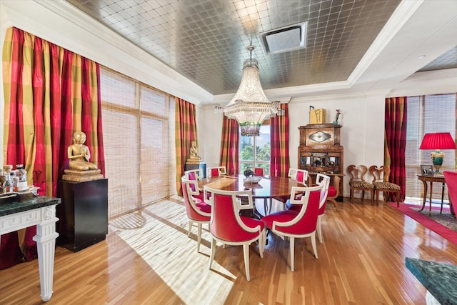 511 S Post Oak Ln Unit 6D, Houston, TX 77056 - dining area with a tray ceiling, hardwood / wood-style flooring, crown molding, and a chandelier