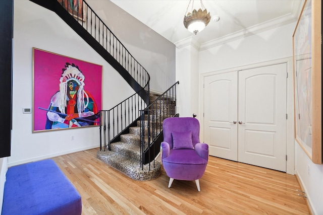 511 S Post Oak Ln Unit 6D, Houston, TX 77056 - entryway featuring wood finished floors, stairs, crown molding, and baseboards