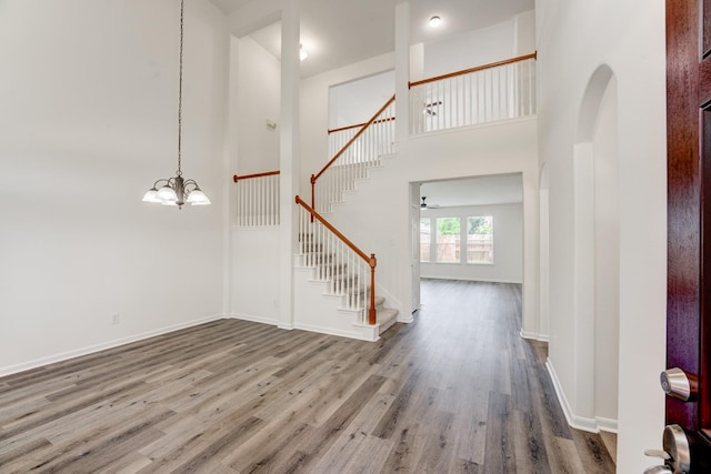 16906 Shoal Park Dr, Cypress, TX 77429 - foyer with stairway, wood finished floors, a chandelier, baseboards, and a high ceiling