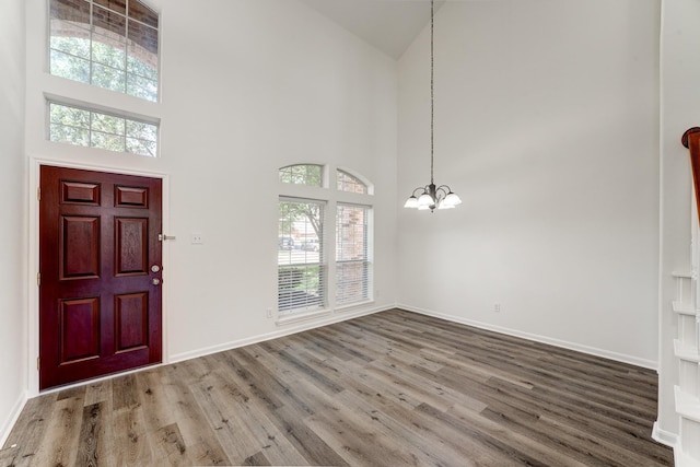 16906 Shoal Park Dr, Cypress, TX 77429 - entryway with high vaulted ceiling, a chandelier, wood finished floors, and baseboards