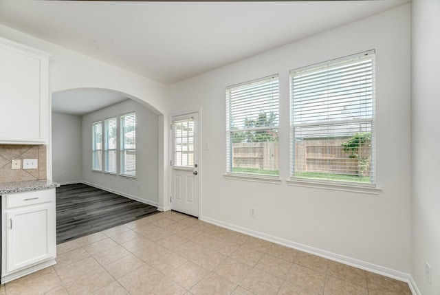 16906 Shoal Park Dr, Cypress, TX 77429 - entryway with baseboards, arched walkways, and light tile patterned floors