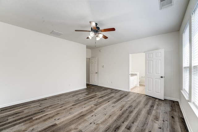 16906 Shoal Park Dr, Cypress, TX 77429 - unfurnished bedroom featuring wood finished floors, connected bathroom, baseboards, and a ceiling fan