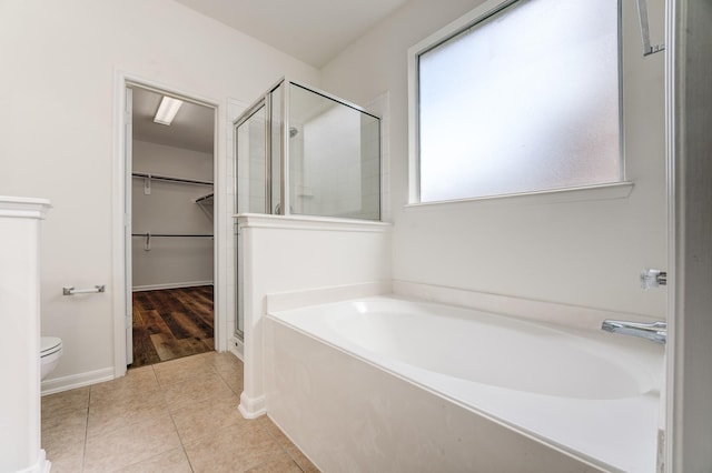 16906 Shoal Park Dr, Cypress, TX 77429 - bathroom featuring a garden tub, a stall shower, a spacious closet, toilet, and tile patterned floors