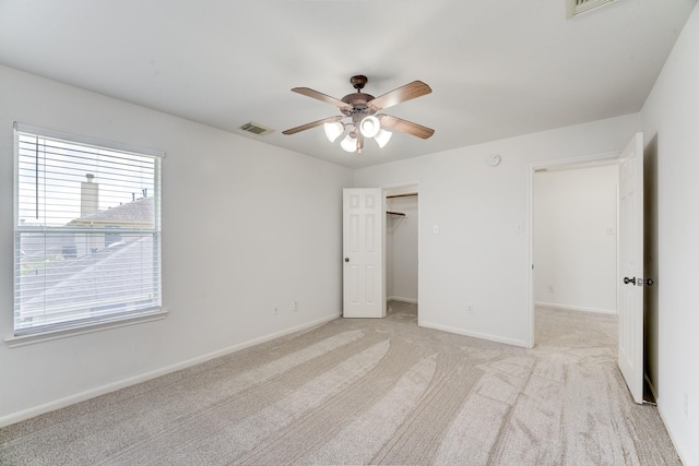 16906 Shoal Park Dr, Cypress, TX 77429 - unfurnished bedroom featuring light carpet, baseboards, a ceiling fan, and a spacious closet
