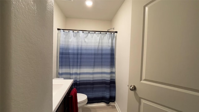 21138 Titian Dr, Magnolia, TX 77355 - full bath with vanity, a textured wall, toilet, and a shower with curtain