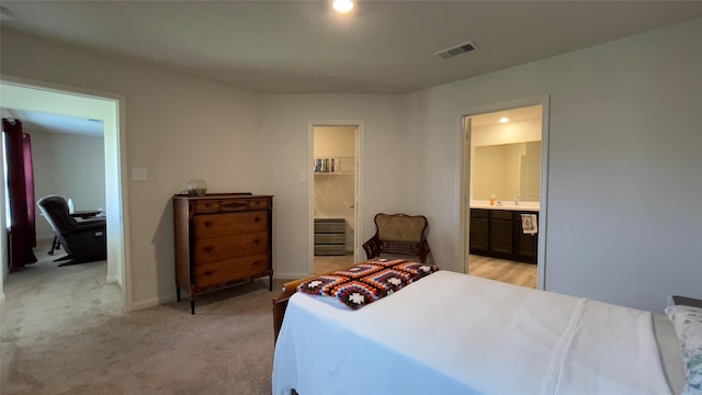 21138 Titian Dr, Magnolia, TX 77355 - bedroom with a walk in closet, connected bathroom, light carpet, and a closet