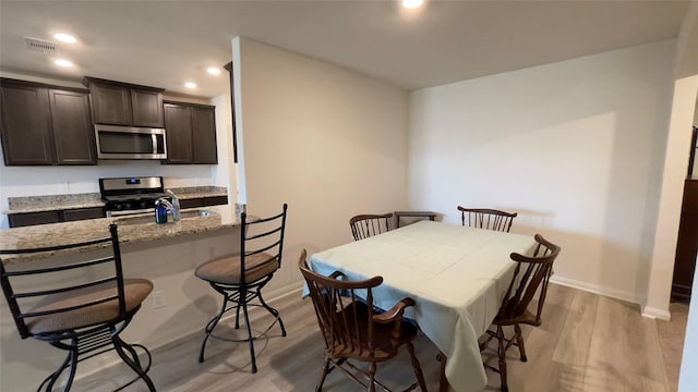 21138 Titian Dr, Magnolia, TX 77355 - dining room with light wood finished floors, baseboards, and recessed lighting
