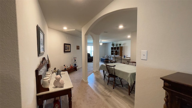 21138 Titian Dr, Magnolia, TX 77355 - hallway with arched walkways, recessed lighting, light carpet, and light wood-style flooring