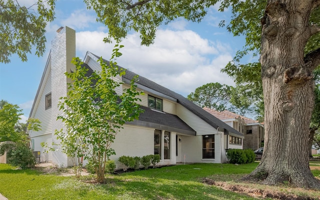 8014 Wray Ct, Houston, TX 77088 - back of property with a yard, a chimney, brick siding, and a shingled roof
