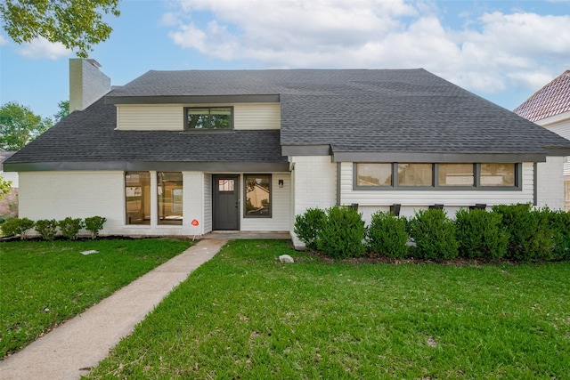 8014 Wray Ct, Houston, TX 77088 - view of front facade featuring brick siding, roof with shingles, a front lawn, and a chimney
