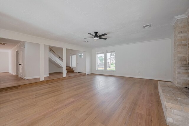 8014 Wray Ct, Houston, TX 77088 - unfurnished living room with ceiling fan, stairs, light wood-style floors, crown molding, and baseboards