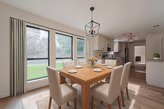 8014 Wray Ct, Houston, TX 77088 - dining room with a chandelier and light wood finished floors