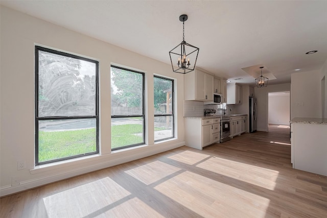 8014 Wray Ct, Houston, TX 77088 - kitchen featuring a chandelier, light wood finished floors, white cabinetry, and a sink