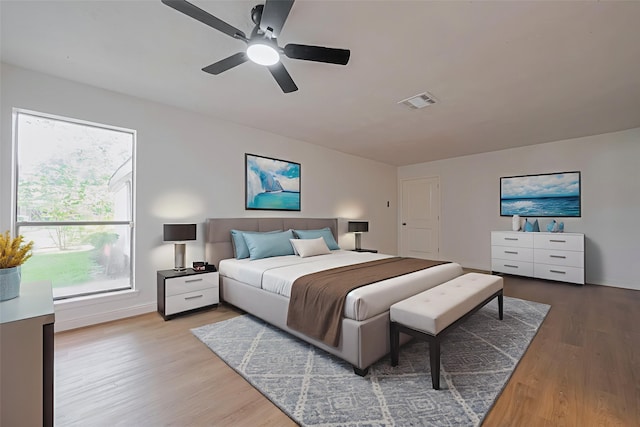 8014 Wray Ct, Houston, TX 77088 - bedroom featuring wood finished floors, multiple windows, baseboards, and a ceiling fan