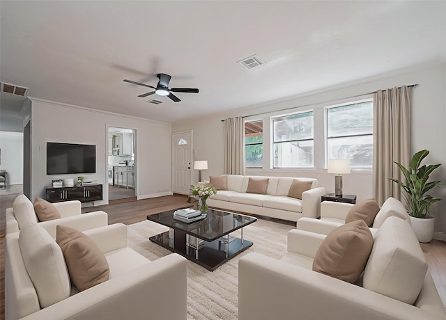 8014 Wray Ct, Houston, TX 77088 - living area featuring wood finished floors, a ceiling fan, baseboards, and crown molding